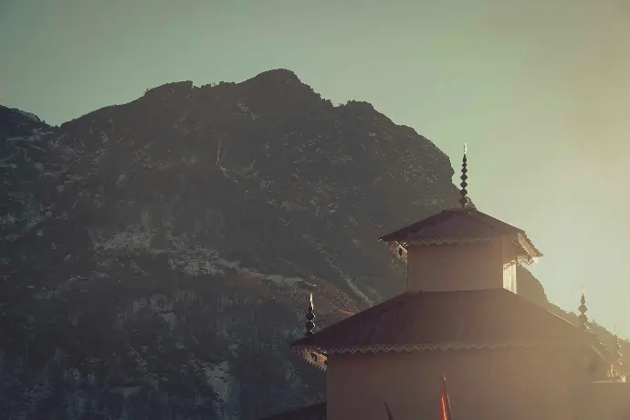 a large building with a steeple on top of a mountain
